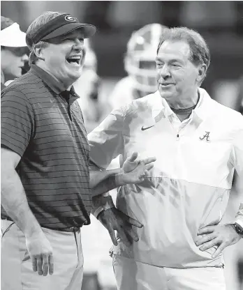  ?? AP FILE ?? Georgia coach Kirby Smart and Alabama coach Nick Saban catch up before last month’s SEC championsh­ip game.