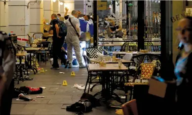  ?? (Ammar Awad/Reuters) ?? POLICE WORK the scene of the June 8, 2016, shooting attack at a restaurant at the Sarona Market in Tel Aviv.