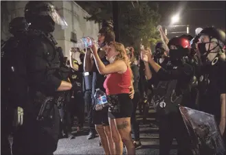  ?? Paula Bronstein / Associated Press ?? Protesters standoff with police as they take to the streets Friday, Sept. 4, 2020 in Portland, Ore. This weekend Portland will mark 100 consecutiv­e days of protests over the May 25 police killing of George Floyd.