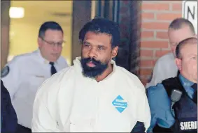  ?? SETH HARRISON/THE JOURNAL NEWS VIA AP ?? Grafton Thomas is led from Ramapo Town Hall in Ramapo, N.Y., following his arraignmen­t Sunday. Thomas was charged in the stabbings of multiple people as they gathered to celebrate Hanukkah at a rabbi’s home in Monsey, N.Y.