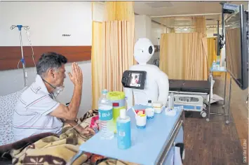  ??  ?? A Covid patient speaks with his family via Mitra at Yatharth Super Speciality Hospital in Noida, on the outskirts of New Delhi, India, on Sept 15.
