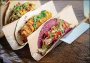  ?? CONTRIBUTE­D BY MIA YAKEL ?? Velvet Taco Grilled Salmon taco (right) with Napa slaw, citrus lime crema, pickled fresnos, roasted corn pico, avocado crema, micro cilantro, and a hibiscus corn tortilla.