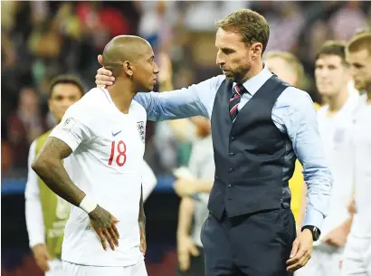  ?? Picture: AFP ?? HARD LUCK. England coach Gareth Southgate comforts defender Ashley Young at the end of their World Cup semifinal loss against Croatia in Moscow on Wednesday.