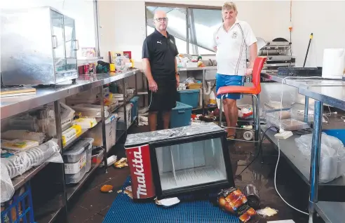  ?? Pictures: STEWART McLEAN ?? MESS: Southside Comets football director Chris Collins and Gavern Lovett from Queensland Cricket see the damage.