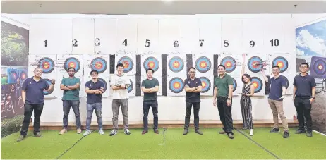  ?? ?? Abigail (third from right) with her team during an indoor archery session.