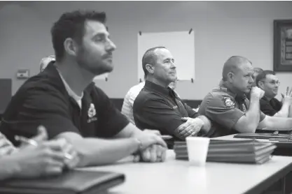  ?? Staff photo by Joshua Boucher ?? n LEFT: Area law enforcemen­t officers meet at the Troop G State Police Station on Tuesday for a simulation of a child abduction in Hope, Ark.