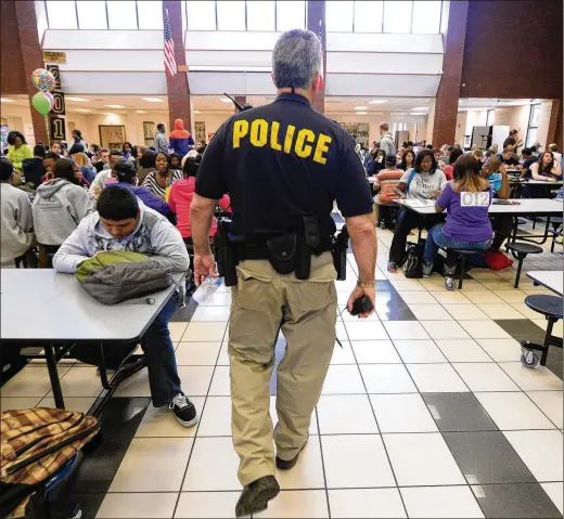  ?? AJC FILE ?? More schools in recent years have relied on the presence of armed school resource officers, aka police, to tamp down the potential for violence on campus and to be prepared to react quickly to save lives in the event of a school shooting. But the effectiven­ess of such a plan is debatable.