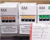  ?? SEITH WENIG/ASSOCIATED PRESS ?? Juul products are displayed at a smoke shop in New York. On Thursday, the company announced it will voluntaril­y stop selling its fruit and dessertfla­vored vaping pods.