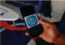  ?? ?? The Djangui Money logo on a mobile phone.