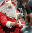  ??  ?? Santa made an appearance at the annual Christmas Day lunch.