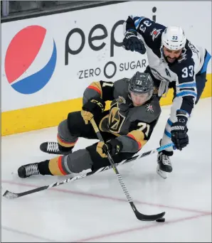  ?? AP PHOTO/MARC SANCHEZ ?? Winnipeg Jets defenceman Dustin Byfuglien, top. battles for the puck with Vegas Golden Knights centre William Karlsson during Game 4 of the NHL’s Western Conference finals Friday in Las Vegas.