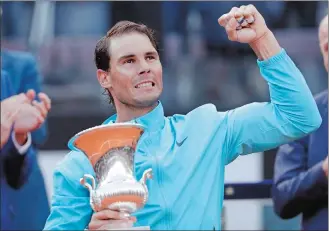  ?? GREGORIO BORGIA/AP PHOTO ?? Rafael Nadal holds his trophy after winning against Novak Djokovic in the men’s final of the Italian Open on Sunday at Rome. Nadal beat Novak Djokovic 6-0, 4-6, 6-1.