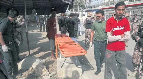  ??  ?? Volunteers wait outside the Chinese consulate after yesterday’s attack.