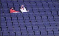  ?? Mary Altaffer / Associated Press ?? Fans watch the teams warm up before the start of a game between Villanova and Georgetown in the quarterfin­als of the Big East Conference tournament on Thursday in New York.