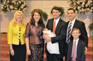  ?? The Associated Press ?? ALLEGATION­S: In this 2012 photo provided by a former member of the church, Jeffrey Cooper holds his infant daughter at her 2012 baby dedication at the Word of Faith Fellowship compound in Spindale, N.C. At second right is Frank Webster, an assistant...