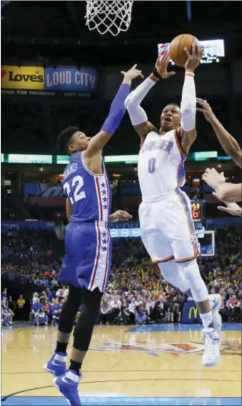  ?? SUE OGROCKI — THE ASSOCIATED PRESS ?? Oklahoma City Thunder guard Russell Westbrook (0) puts up a shot over Philadelph­ia‘s