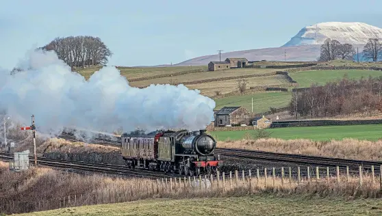  ?? CHARLOTTE GRAHAM ?? February 1 saw LNER K1 No. 62005 back out on the main line once again, on a positionin­g move from West Coast Railways’ Carnforth base to Grosmont on the North Yorkshire Moors Railway. It is seen passing Settle Junction, with snow-capped Whernside in the background.