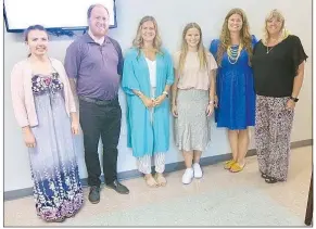  ?? Westside Eagle Observer/SUSAN HOLLAND ?? Six new faculty members at Gravette schools smile for the camera Aug. 16 after being introduced by superinten­dent Maribel Childress during the Gravette School Board meeting. New hires who attended the meeting are Gabrielle Hamilton, music teacher/interventi­onist at Gravette Upper Elementary; Justin Garton, theater arts teacher at Gravette High School; Samantha Luther, social studies teacher and head softball coach at Gravette High School; Emma Wisdom, PE teacher at Glenn Duffy Elementary and assistant basketball coach; Brandi Brown, art teacher/interventi­onist at Glenn Duffy Elementary; and Carolyn Huntsman, Title I teacher at Gravette Upper Elementary.