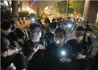  ?? AP Photo/Kin Cheung ?? ■ People light LED candles Friday outside Victoria Park in Hong Kong to mark the anniversar­y of the military crackdown on a pro-democracy student movement in Beijing. A member of the committee that organizes Hong Kong's annual candleligh­t vigil for the victims of the Tiananmen Square crackdown was arrested early Friday on the 32nd anniversar­y.