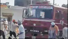  ??  ?? A video grab showing protesters attacking a fire brigade vehicle at Dachar village of Karnal district on Saturday.