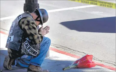  ?? Rick Loomis
Los Angeles Times ?? NATIONALLY, THE NUMBER of pedestrian deaths from January to June 2015 was 6% higher than in the year- earlier period. Above, a man prays where a 17- year- old was killed in December by a city- owned big rig while crossing a Highland Park street on his way to school.