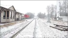  ?? Westside Eagle Observer/MIKE ECKELS ?? About an inch of snow covers the tracks and railroad right-of-way near the Decatur Depot in January as Winter Storm Izzy began to intensify over Arkansas. By late evening an estimated three to five inches plus fell over Northwest Arkansas.