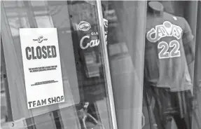  ?? KEN BLAZE/USA TODAY SPORTS ?? A sign at the Cleveland Cavaliers team shop at Rocket Mortgage FieldHouse explains that the shop is closed until further notice.