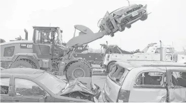  ?? Karl Merton Ferron / Baltimore Sun via Associated Press ?? Mangled vehicles collect on the Interstate 95 shoulder after a series of crashes shut down the highway in Baltimore on Saturday, when an ice storm sparked a chain-reaction wreck involving dozens of vehicles.