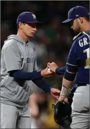  ?? (AP/David Zalubowski) ?? Milwaukee Brewers Manager Craig Counsell (left) will have several intrasquad scrimmages as the Brewers try to simulate the intensity of a real game in the lead up to the regular season.