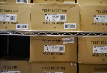  ?? Associated Press ?? Boxes containing Yeezy shoes made by Adidas are seen at Laced Up, a sneaker resale store, in Paramus, N.J. Adidas’ breakup with rapper Kanye West and the inability to sell his popular Yeezy line of shoes helped batter the company’s earnings at the end of last year.