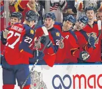  ?? ALAN DIAZ/AP ?? Nick Bjugstad (27) is congratula­ted by his Panther teammates after scoring a first-period goal against the Pittsburgh Penguins at BB&T Center in Sunrise on Monday.