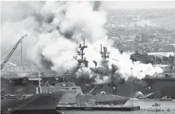  ?? DENIS POROY/ AP 2020 ?? Smoke rises from the USS Bonhomme Richard at Naval Base San Diego after an explosion and fire on board the ship. The ship was destroyed in the blaze.