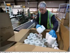  ?? (AP/Robert F. Bukaty) ?? Scott Mitchell fills a box with toilet paper last week at the Tissue Plus factory in Bangor, Maine. The new company has been busy as consumers’ stockpilin­g has led to a shortage of toilet paper.