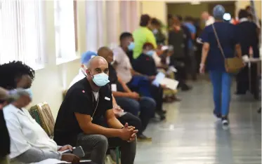  ??  ?? Healthcare workers waiting for their turn to be vaccinated at the Tygerberg Hospital. The Johnson & Johnson’s Covid-19 vaccine is mainly for healthcare workers as the country starts Phase 1 of the vaccine rollout. | Phando Jikelo African News Agency (ANA)