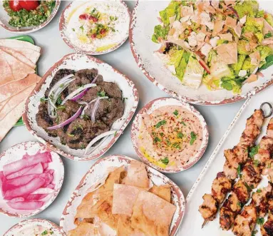  ?? Photos by Yi-Chin Lee / Staff photograph­er ?? Craft Pita’s mezze dinner comes with chicken and beef, three spreads, tabouli, pickled turnips, rice pilaf and homemade chips and pita bread.