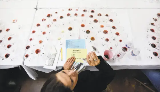  ??  ?? Above: Sixty-seven judges participat­ed in the 2018 San Francisco Chronicle Wine Competitio­n Sweepstake­s at the Cloverdale Citrus Fairground­s in January. Below left: Almost 7,000 wines were entered into the competitio­n. Below right: San Francisco...