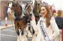  ?? PAULW. GILLESPIE/CAPITAL GAZETTE ?? Miss America 2020 Camille Schrier, Grand Marshal of the 2019 Military Bowl Parade, meets the Budweiser Clydesdale­s before the parade begins at City Dock.