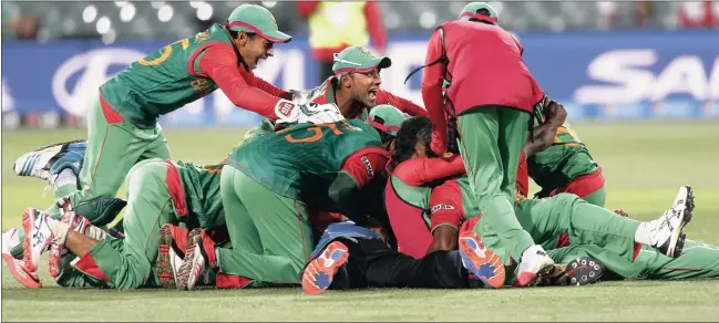  ?? Picture: DAVID GRAY, REUTERS ?? PILE OF JOY: Bangladesh celebrate a famous victory after knocking England out of the World Cup yesterday.