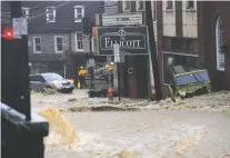  ?? KATHERINE FREY/WASHINGTON POST ?? The main street in Ellicott City, Md., became a raging river Sunday during a torrential downpour that lasted hours, just two years after another flash flood devastated the historic downtown.