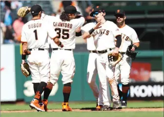  ?? Tribune News Service/mercury News ?? San Francisco Giants players celebrate after defeating Texas Rangers 4-2 at Oracle Park in San Francisco on Tuesday, May, 11, 2021.