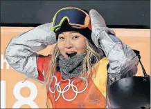  ?? [GREGORY BULL/THE ASSOCIATED PRESS] ?? Chloe Kim likes what she sees when her scores were revealed after her women’s halfpipe final run.