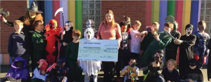  ??  ?? Brenda McCarthy from the Irish Cancer Society accepts a cheque from the students at St Joseph’s CBS.