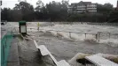  ??  ?? The swollen Parramatta river is seen breaking its banks at the Charles St weir and ferry wharf, at Parramatta in Sydney