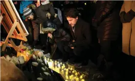  ??  ?? The prime minister, Justin Trudeau, places a candle on Parliament Hill during vigil for the victims who were killed in a plane crash in Iran in Ottawa, Canada. Photograph: Dave Chan/ Getty Images