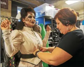  ?? SUBMITTED PHOTO ?? Alisa Kleckner of Montgomery Township secures the costume for one of the actors in Terror Behind the Walls.