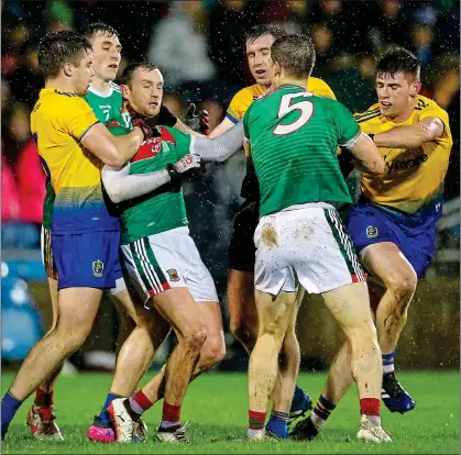  ??  ?? TEMPERS: Mayo’s Keith Higgins comes to the attention of several Roscommon players last night.