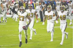  ?? KEVIN SABITUS/ASSOCIATED PRESS FILE PHOTO ?? Saints strong safety Malcolm Jenkins, left, celebrates an intercepti­on against the Buccaneers on Nov. 8 in Tampa, Fla. Jenkins is executive producer of the documentar­y Black Boys. The film focuses on social and emotional effects of racism against Black men and boys.