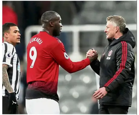  ??  ?? Holding on tight: Manchester United interim manager Ole Gunnar Solskjaer shaking hands with Romelu Lukaku at the end of the Premier League match against Newcastle on Wednesday. — Reuters