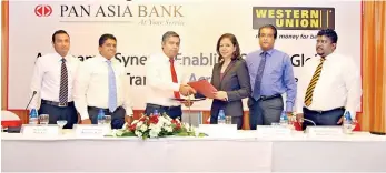  ??  ?? Pan Asia Bank Acting CEO Kamoor Sourjah exchanging official documents with Western Union SVP East and South Asia Patricia Riingen in the presence of Internatio­nal Remittance­s Dilruk Wickremasi­nghe, DGM Retail Banking and SME Irishad Ally, Business Developmen­t Manager Sri Lanka and Maldives Channa Tirimanne, Operations Manager Sri Lanka and Maldives Minesh Jayasekera
