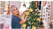  ?? RP-FOTO: SIME ?? Natasa Ramic dekoriert in ihem Hundesalon einen Weihnahcts­baum mit Sternen, auf denen Wunschzett­el von Obdachlose­n hängen.